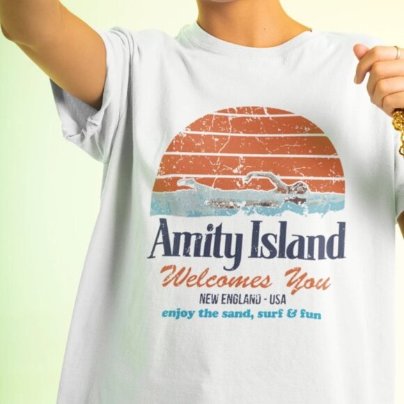 Amity Island Welcomes You New England - USA Enjoy The Sand Surf & Fun Shirt - Picture 1 of 2